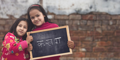 Indian Rural girls holding slate board