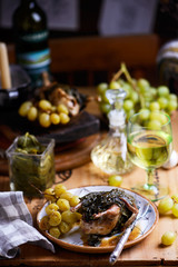 quail in grape leaves with grapes.style vintage