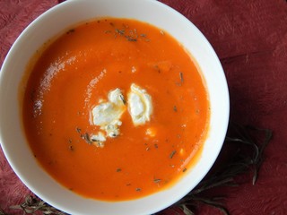 Pumpkin cream soup with cream cheese and dried rosemary in white bowl with salted quiche pie with mexican vegetable mix: carrots, peas, corn, pepper. Healthy home made food concept.