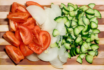 Sliced tomatoes, onions and cucumbers. Top view.