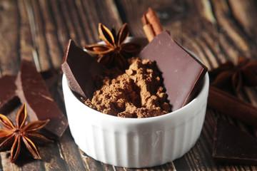 Cocoa powder and a bar of dark chocolate