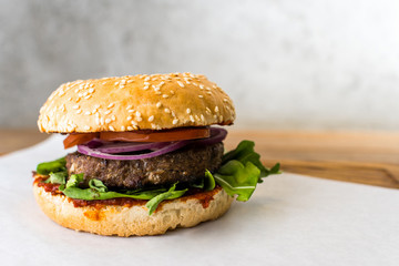 spicy burger on wooden table gray background