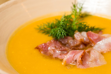 pea soup with bacon on a wooden table