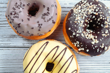 Glazed donuts on wooden background