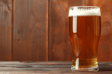 Glass beer on wood background
