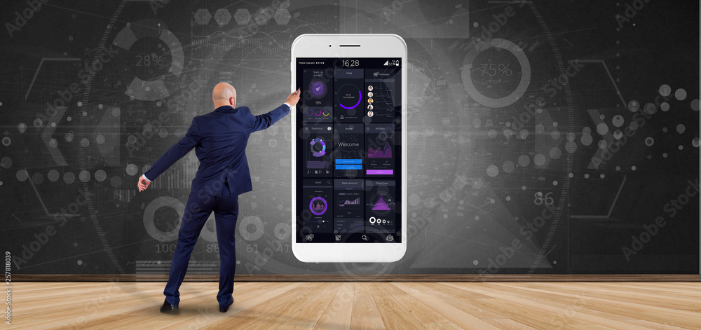 Poster businessman in front of a wall with smartphone with user interface data on the screen isolated on a 