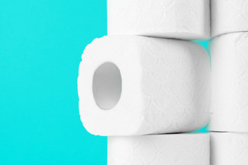 Toilet paper rolls on turquoise bright background