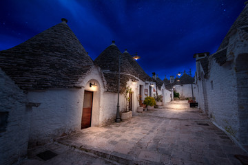 Night view of Alberobello's famous Trulli, the characteristic cone-roofed white houses of the Itria Valley, Apulia, Southern Italy. ALBEROBELLO, PUGLIA, ITALY