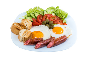 breakfast fried egg fresh vegetables fried sausages and olives on a white plate isolated