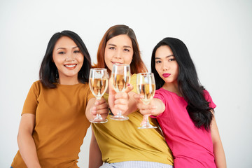 Happy women friends with champagne