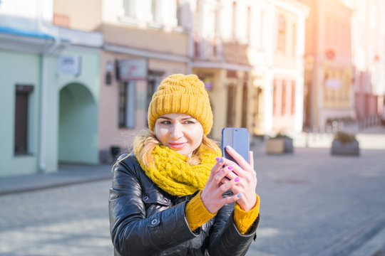 young stylish smiling pretty woman taking pictures selfie her phone front city street