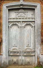 Fototapeta na wymiar Old wooden door painted beige. Beginning of the 20th - the end of the 19th century