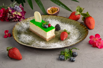 Bamboo cheesecake on a green plate and fruit
