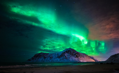 Fototapeta na wymiar Aurora borealis (northern lights) over Skagsanden beach. Lofoten Islands, Norway