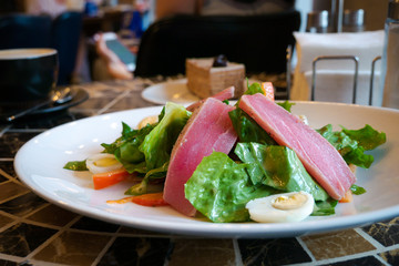 Traditional french Nicoise salad served with fresh tuna slices, lettuce, hard-boiled eggs and...