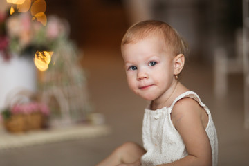 Fototapeta premium Beauty child girl with lace on bench and flowers