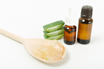 Aloe vera gel on wooden spoon on white background. Aloe vera plant. Natural beauty remedy