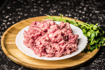 Raw minced pork on white plate