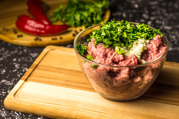 Raw minced pork in a glass bowl