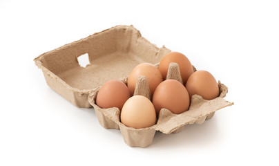 Fresh brown eggs in carton on isolated 