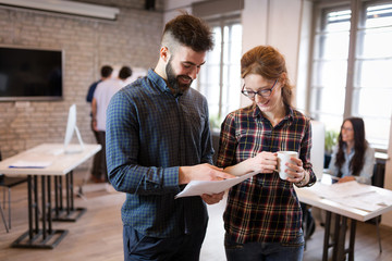 Portrait of young architects discussing in office