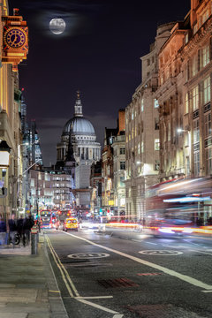 View over London's Fleet Street to the St. Pauls Cathedrale by night with blurred traffic, UK