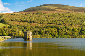 The dam of the Talybont Reservoir with Tor y Foel in the background, Powys, Wales, UK