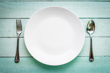 White plate on painted blue wood background