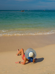 Fototapeta na wymiar Young woman at the tropical beach