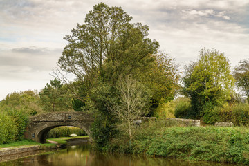 An old stone bridge over the Monmouthshire & Brecon Canal in Pencelli, Powys, Wales, UK