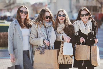 four beautiful women are walking around the city and having fun