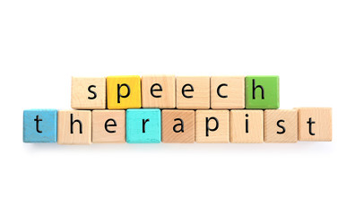 Cubes with text SPEECH THERAPIST on white background