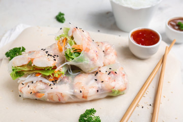 Tasty spring rolls on table