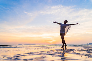 Fototapeta premium Woman on the beach at sunset