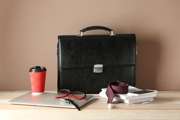 Set of male accessories with laptop on wooden table