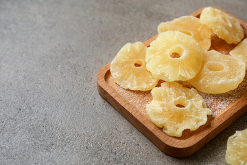 Tasty dried pineapple on grey background