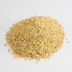 Mountain of sesame seeds on white background
