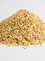 Mountain of sesame seeds on white background