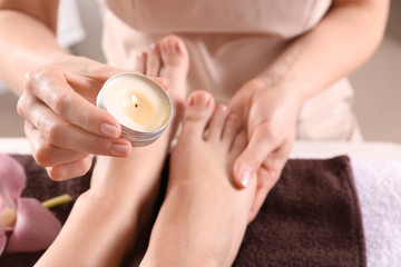 Young woman receiving feet massage in spa salon