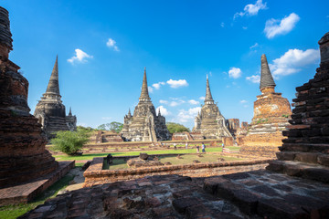 Fototapeta premium Ancient pagoda in Ayutthaya Historical Park covers the ruins of the old city of Ayutthaya, Thailand.