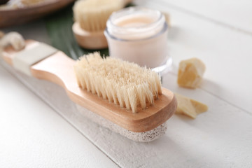 Massage brush on white wooden table