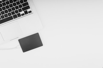Laptop keyboard, storage drive or hard disk on yellow background with selective focus, crop fragment, business, backup, copy space concept. Black and White
