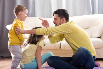 Sibling relationship. Quarrels of the brother and sister. Jealousy in the family. Older child. The father scolds the child. The jealousy of the youngest child. The parents pay little attention to the 