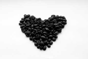 Coffee beans in heart form on white in black and white.