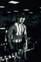 Fototapeta na wymiar muscle guy training in a gym