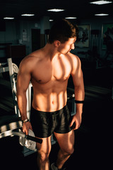 Fototapeta na wymiar muscle guy in a gym