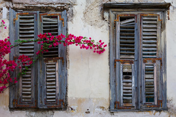 Fototapeta na wymiar Windows of an old abandoned building in the old town of Athens, Greece. 