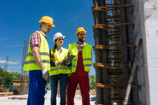 Architect supervising work on the construction site of a building