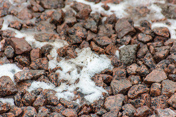 Snow in a pile of gravel