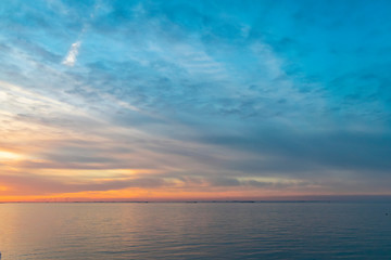 Fototapeta premium The colorful sky at sunset is reflected in the sea. Seascape with sunset. 